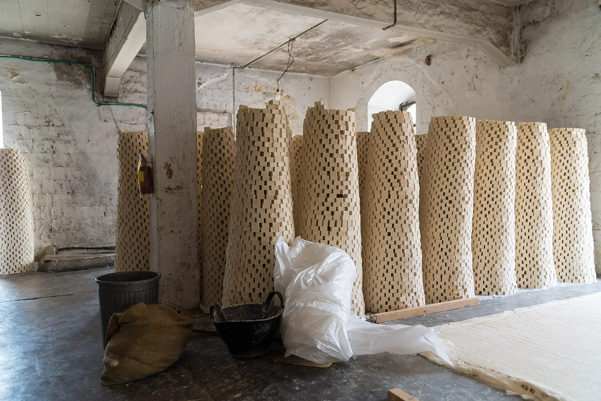 Tall stacked towers of olive-oil soap bars drying inside a whitewashed soap factory in Nablus